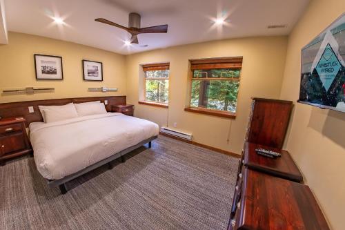 a bedroom with a bed and a ceiling fan at Snowy Creek 04 - Ski In Ski Out, Private Hot Tub, Short Walk to Whistler Village in Whistler