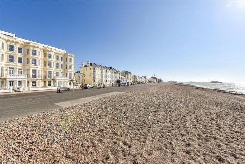 a view of a beach with buildings and the ocean at Modern Home for Small Groups by Stones Throw Apartments - Free Parking - Sea View in Worthing