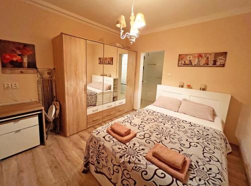 a bedroom with a large bed with two towels on it at Jurincom apartments in Karlovy Vary