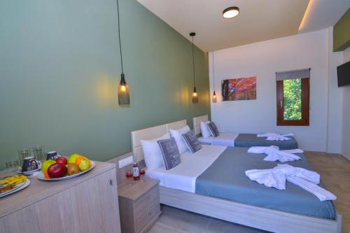 a bedroom with two beds and a bowl of fruit at Elafonisi Paradise with Parking, WiFi, - Walking Distance to the Beach in Elafonisi