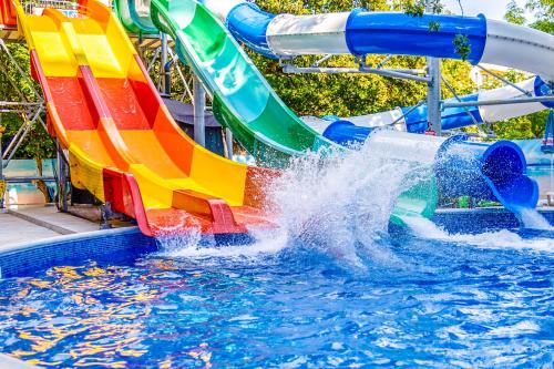 a colorful water slide in a swimming pool at Prestige Deluxe Hotel Aquapark Club - All inclusive in Golden Sands