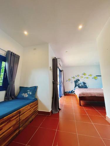 a room with two beds and a red tile floor at Bãi Xếp Beach in Quy Nhon