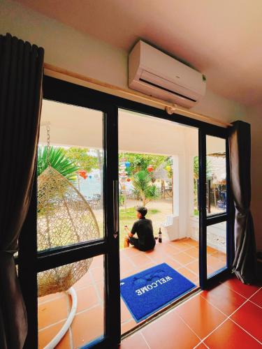 a person sitting on the floor in front of a door at Bãi Xếp Beach in Quy Nhon