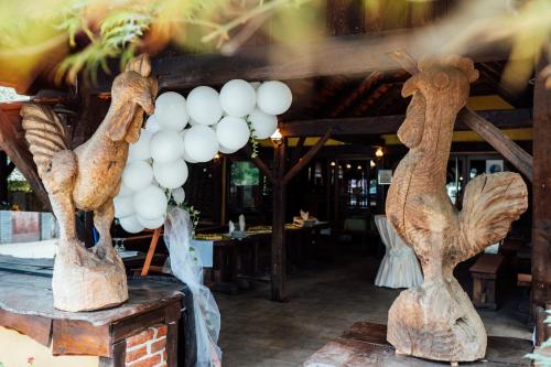a restaurant with a bunch of wood vases on a table at Hotel Picok in Ðurđevac