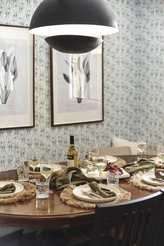 a dining room table with plates and wine glasses at The Stonehouse Nagambie in Nagambie
