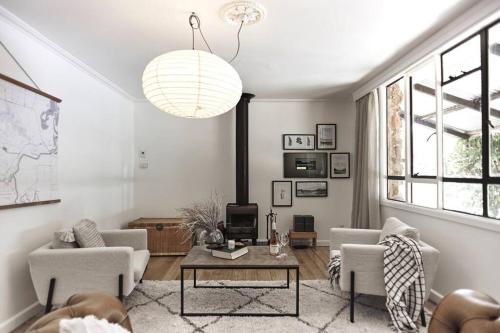 a living room with a couch and a table at The Stonehouse Nagambie in Nagambie