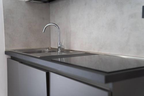 a kitchen counter with a sink in a kitchen at [GALLERIA DUOMO] Luxury Design Apartment in Brescia