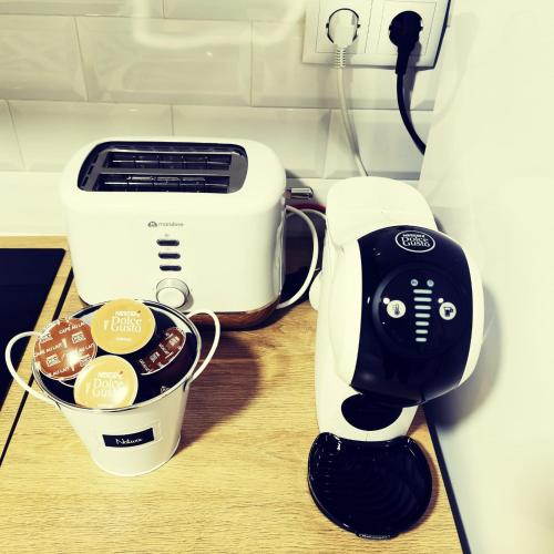 a white and black mixer next to a bowl of food at Laurel No5 in Logroño