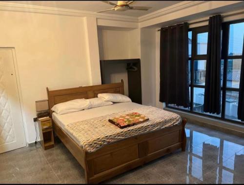 a bedroom with a bed with a tray of food on it at BAFFOUR APARTMENTS in Adiebaba