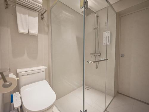 a bathroom with a toilet and a glass shower at The Leap Seoul Sadang in Seoul