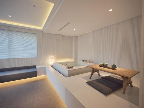 a living room with a table and a bath tub at The Leap Seoul Sadang in Seoul