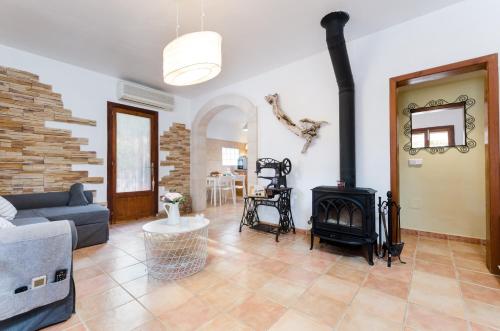 a living room with a couch and a fireplace at Cas Pati (Son Moja) in Santanyi