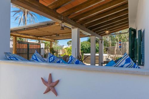 a row of blue chairs on a patio at Cas Pati (Son Moja) in Santanyi