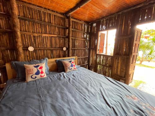 a bedroom with a bed in a wooden cabin at Bãi Xếp Beach in Quy Nhon