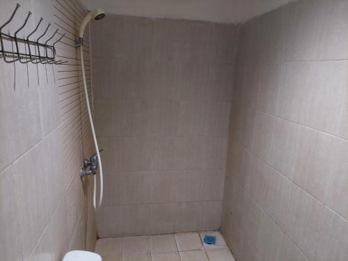 a bathroom with a shower and a toilet at Pondok Seruni Kemanggisan Jakarta in Jakarta