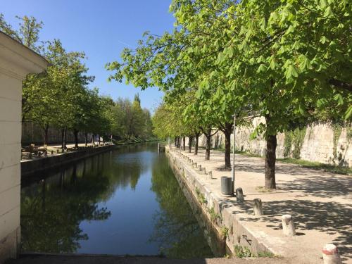 a river with trees on the side of it at City Apartment am Lendkanal, Klagenfurt in Klagenfurt