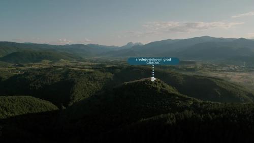 a blue sign sitting on top of a mountain at Seosko domaćinstvo Kastratović in Berane