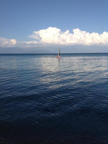 a sailboat in the middle of a large body of water at Camvillia Resort Messinia in Vounaria