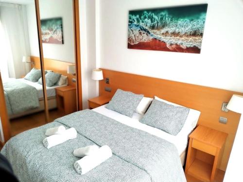 a hotel room with two beds with towels on them at Wanda IFEMA Aeropuerto Madrid JC in Madrid