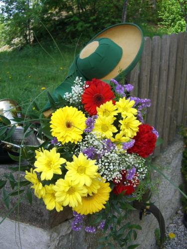 a bunch of flowers sitting on a chair at Residence Laitacherhof - Modern Apartments with Sauna in Chiusa