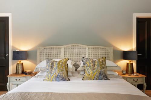a bedroom with a white bed with two lamps at Luxurious Interior Designed Home in Kenmare