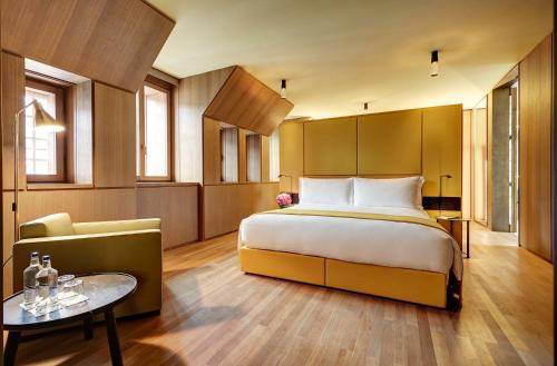 a hotel room with a bed and a table at Hotel Cafe Royal in London