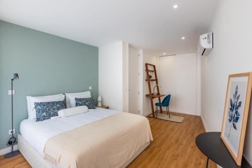 En eller flere senge i et værelse på Pestana Apartments - Premium