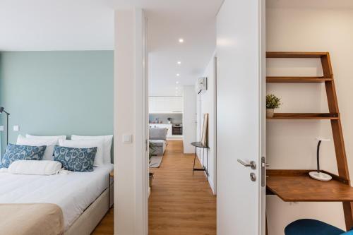 a small apartment with a bed and a hallway at Pestana Apartments - Premium in Porto