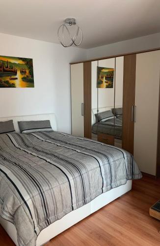 a bedroom with a large bed and a mirror at Vienna Gate apartment in Bratislava