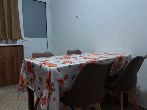 a dining room table with a flowered table cloth at Costas Two-bedroom ground floor apartment in Paphos City