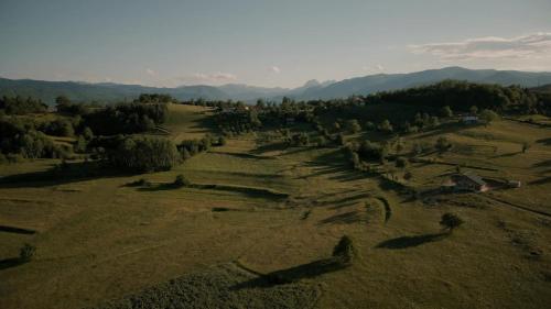 an aerial view of a field with trees and houses at Seosko domaćinstvo Kastratović in Berane