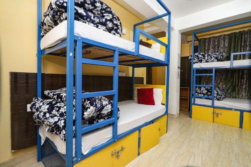 a room with bunk beds in a hostel at Moustache Mcleodganj in McLeod Ganj