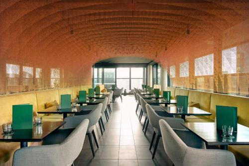 a row of tables and chairs in a restaurant at Quincy Hotel Melbourne in Melbourne