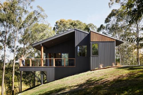 a black house on a hill with trees at Cedars Mount View (Adults Only) in Mount View