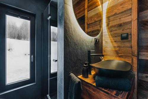 a bathroom with a bath tub and a window at Stare Szałasy in Klikuszowa