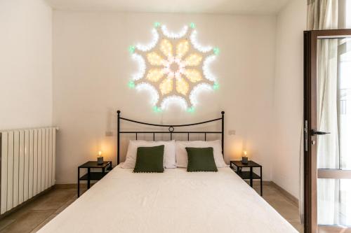a bedroom with a large bed with two side tables at Trullibellula in Alberobello