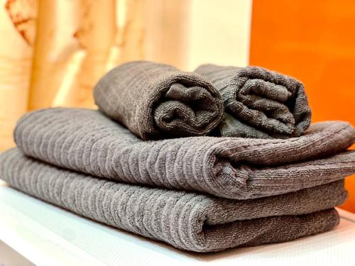 a stack of towels sitting on a shelf at K22 Filtrowa Apart Warsaw in Warsaw