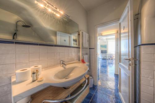 a bathroom with a sink and a mirror at Beach House Camogli in Camogli