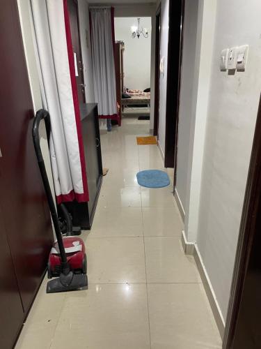a long hallway with a vacuum in a room at Hostel - bedspace for Ladies سكن - سرير للبنات in Al Khān