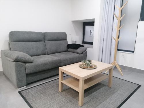 a living room with a couch and a coffee table at Asturin House - PARKING GRATIS in Salamanca