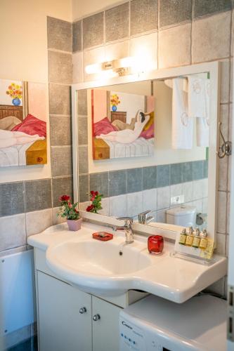 a bathroom with a sink and a mirror at Monambeles Villas in Svoronata