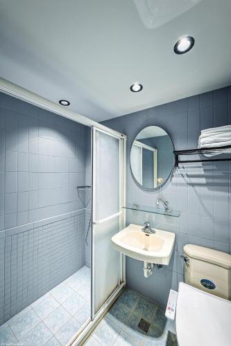 a bathroom with a shower and a sink and a toilet at 亞馨文旅 近東大門夜市 有免費停車場 可自助入住 in Hualien City