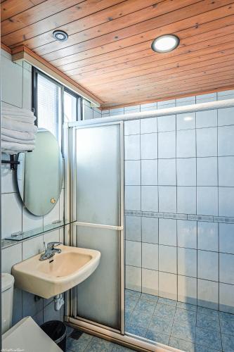 a bathroom with a sink and a shower at 亞馨文旅 近東大門夜市 有免費停車場 可自助入住 in Hualien City