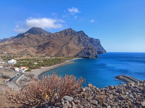 a view of a beach with a mountain in the background at MINI estudio El Reloj in La Aldea de San Nicolas