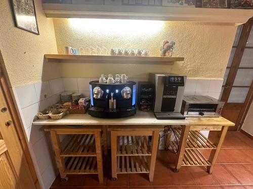 a counter with a coffee maker and a microwave on it at Hotel Torino in Masnou