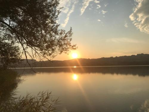 a view of a lake with the sun setting at Hotel Garni Dorferwirt am Irrsee in Tiefgraben