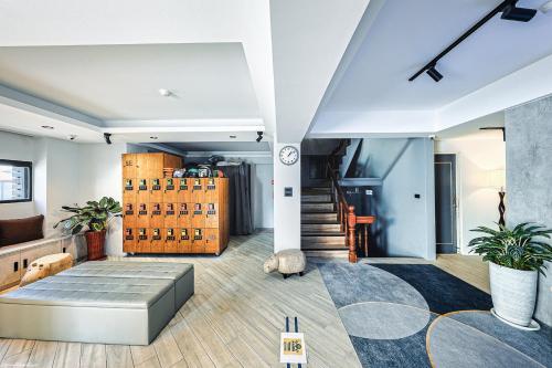 a living room with a bed and a staircase at 亞馨文旅 近東大門夜市 有免費停車場 可自助入住 in Hualien City