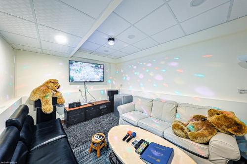 a living room with two teddy bears sitting on a couch at 亞馨文旅 近東大門夜市 有免費停車場 可自助入住 in Hualien City