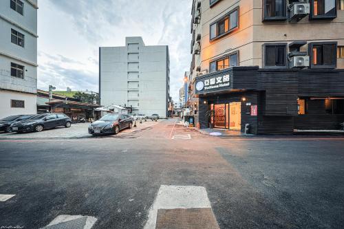 an empty city street with cars parked on the street at 亞馨文旅 近東大門夜市 有免費停車場 可自助入住 in Hualien City