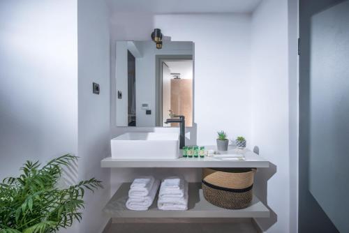 a bathroom with a sink and a mirror at Meramaglia Hotel in Malia